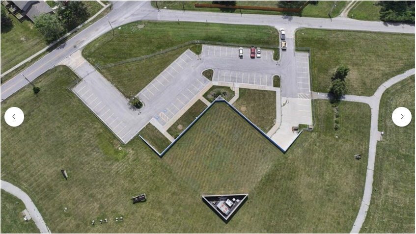 Aerial view — full property showing L-shaped building
