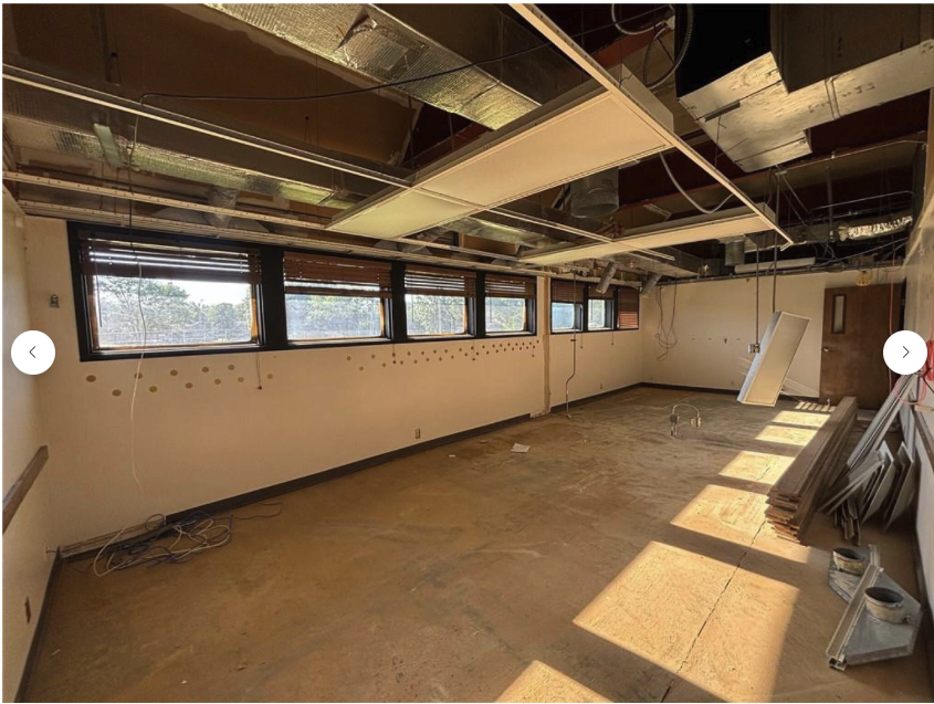 Interior renovation — gutted room with window bank