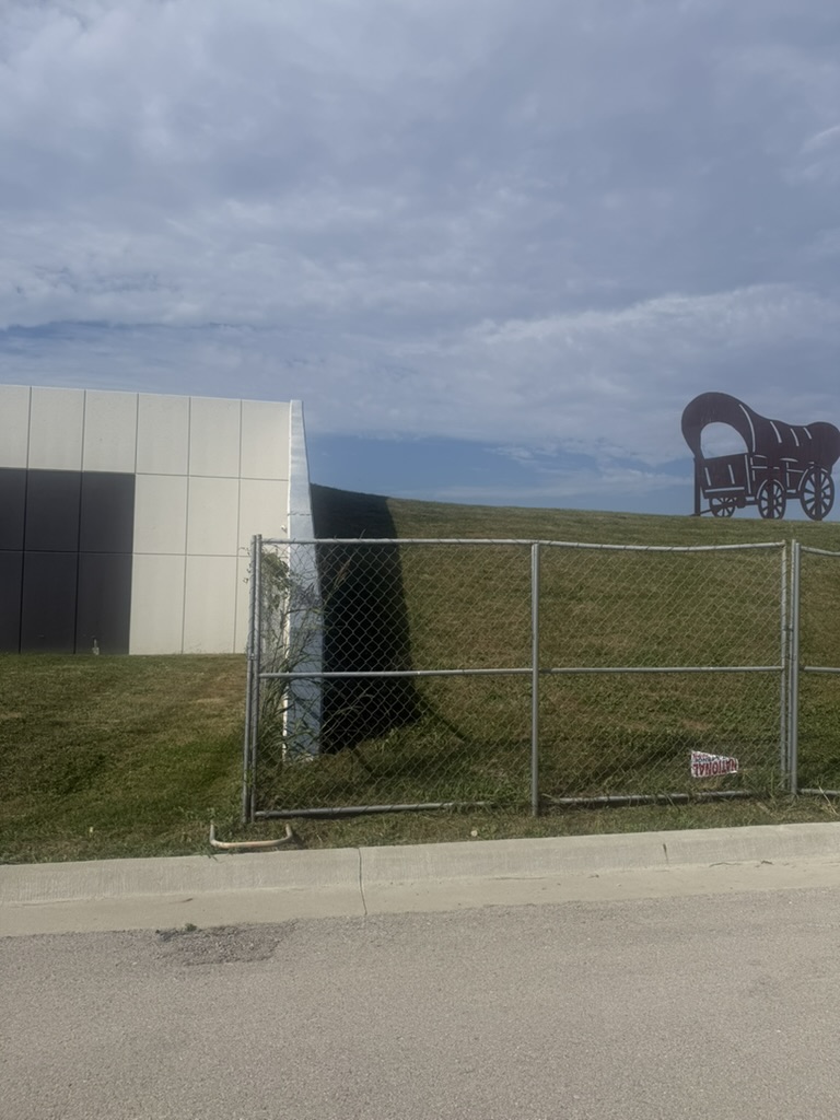 Building rear with chain-link fencing